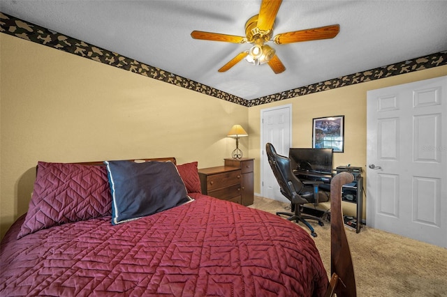 carpeted bedroom with a textured ceiling and ceiling fan