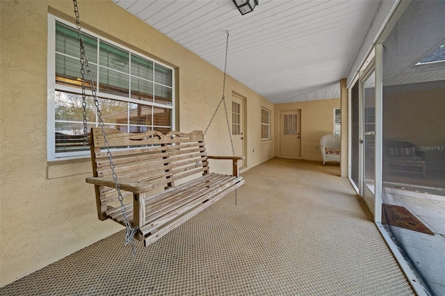 sunroom featuring lofted ceiling