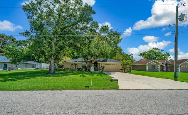 single story home featuring a garage and a front yard