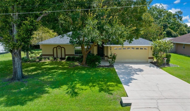 ranch-style home featuring a garage, concrete driveway, roof with shingles, stucco siding, and a front lawn