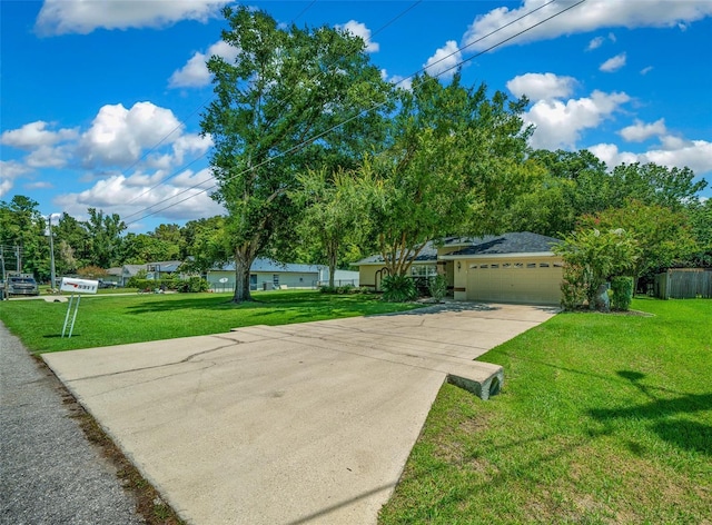 ranch-style home featuring a front yard, driveway, and an attached garage