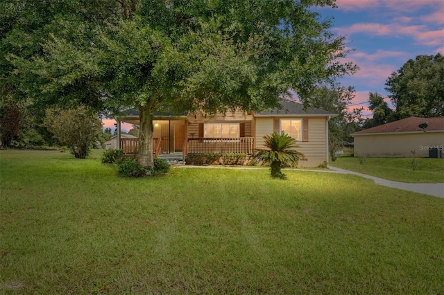 view of front of property featuring a yard and covered porch