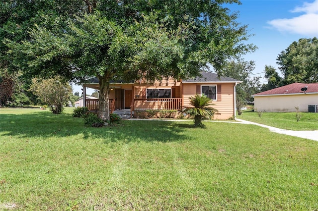 view of front of house with a front yard, covered porch, and central air condition unit