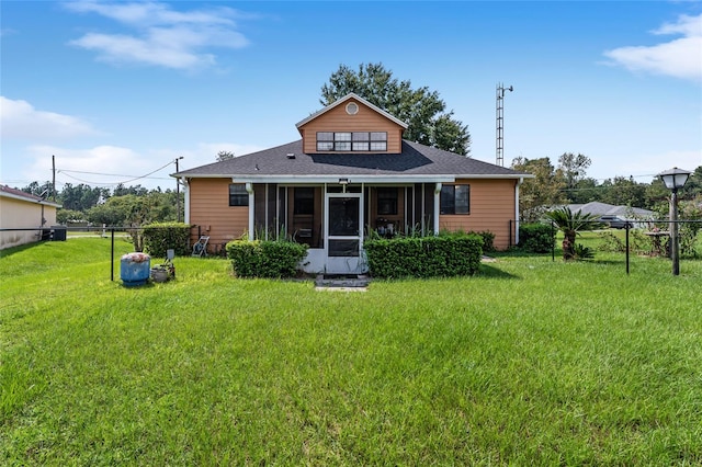 rear view of house featuring a lawn