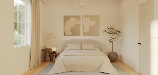 bedroom with ceiling fan and light hardwood / wood-style floors