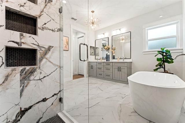 bathroom featuring separate shower and tub, vanity, and a notable chandelier