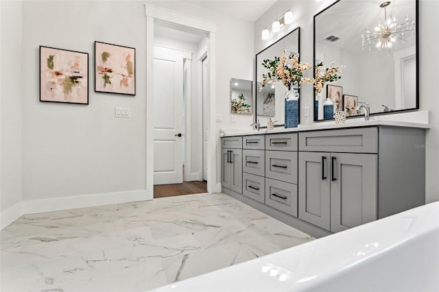 bathroom with vanity and a notable chandelier