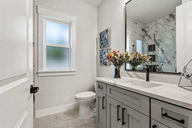 bathroom featuring toilet, vanity, a healthy amount of sunlight, and walk in shower