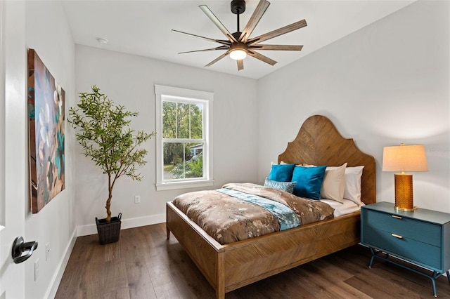 bedroom with ceiling fan and dark hardwood / wood-style flooring