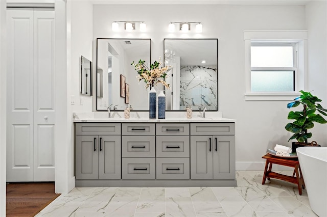 bathroom featuring vanity and independent shower and bath