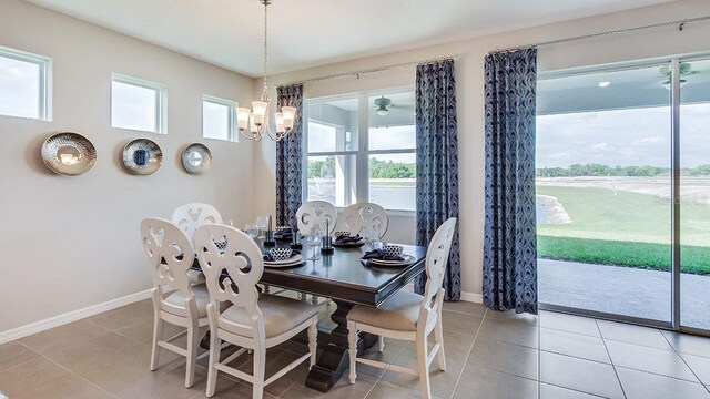 dining room featuring light tile patterned flooring and an inviting chandelier