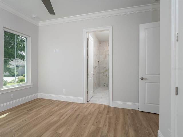 unfurnished bedroom featuring light hardwood / wood-style floors, ornamental molding, ceiling fan, and ensuite bath