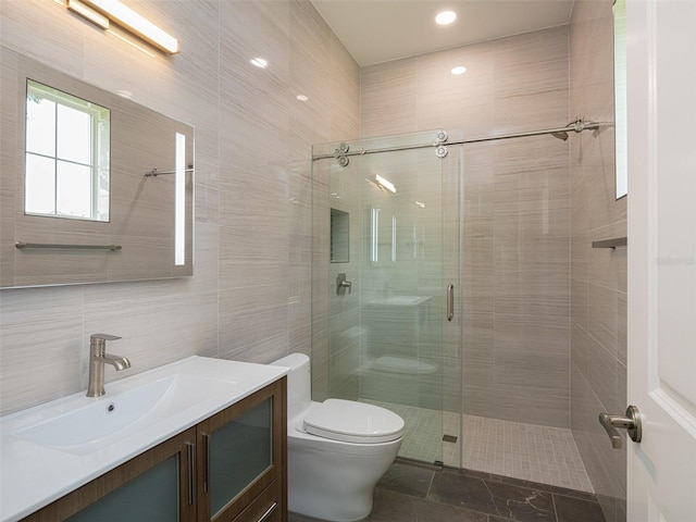 full bath featuring backsplash, toilet, vanity, a stall shower, and tile walls