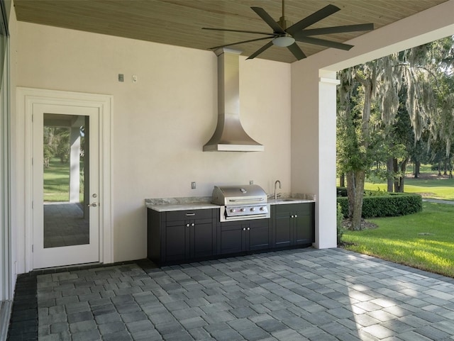 view of patio / terrace with exterior kitchen, a grill, a ceiling fan, and a sink
