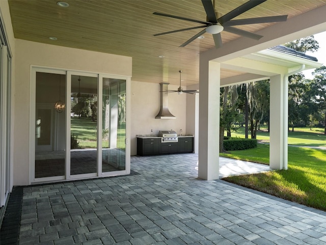 view of patio / terrace with a grill, exterior kitchen, and a ceiling fan