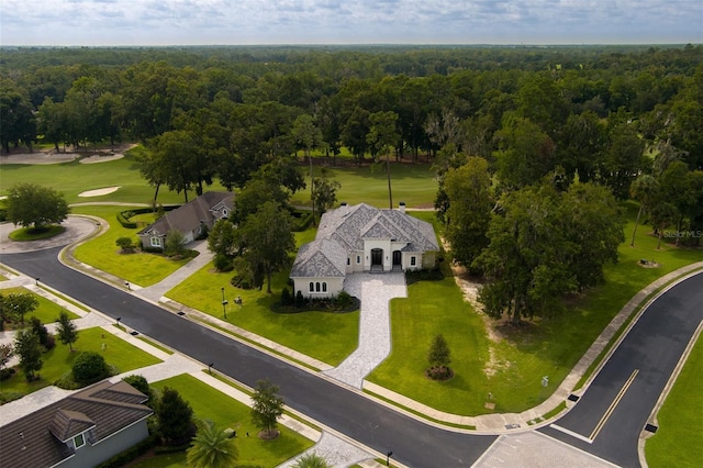 bird's eye view with a wooded view