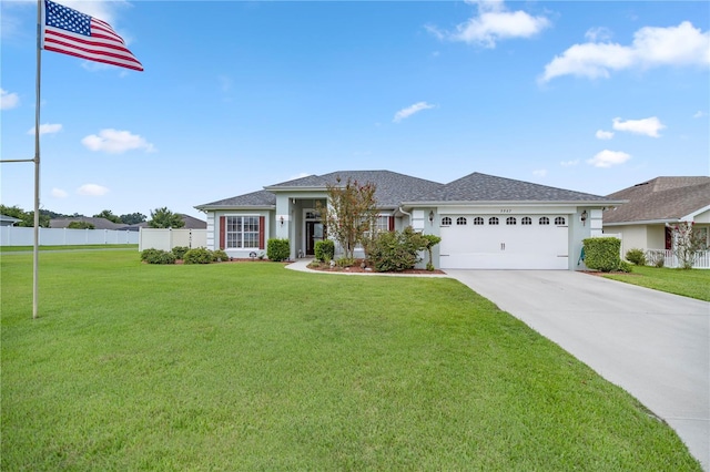 3967 SE 99th St, Belleview, FL 34420 - view of front of property with stucco siding, driveway, fence, a front yard, and an attached garage