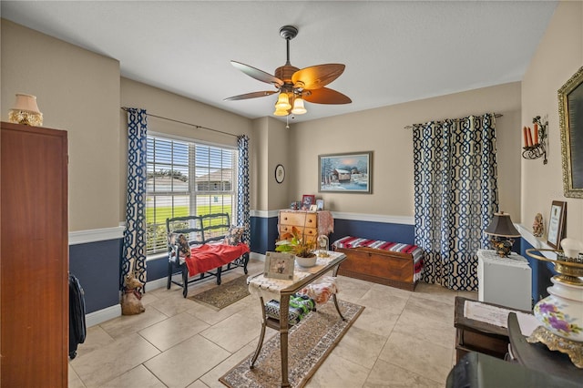 sitting room with ceiling fan and light tile patterned floors