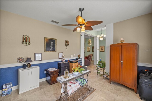 interior space featuring light tile patterned flooring and ceiling fan with notable chandelier