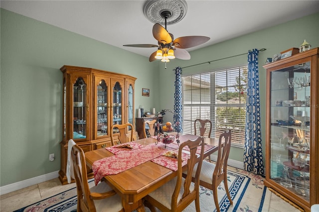 tiled dining space featuring ceiling fan