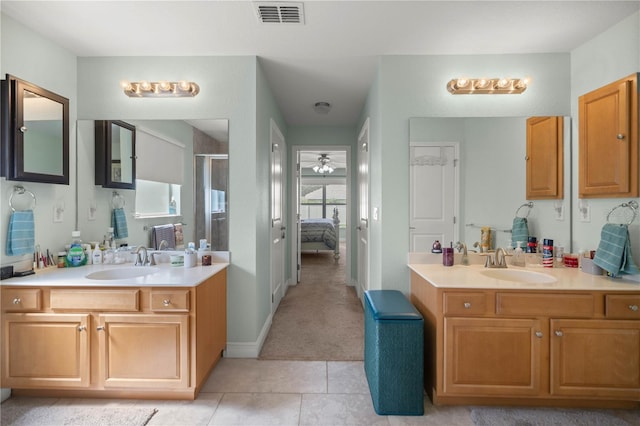 bathroom featuring tile patterned flooring, vanity, ceiling fan, and an enclosed shower