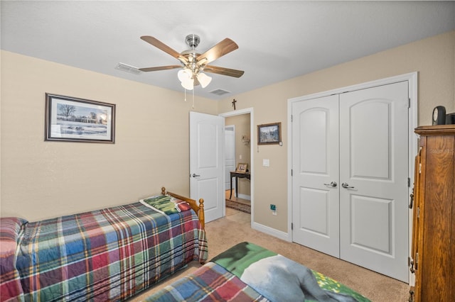 bedroom featuring light carpet, a closet, and ceiling fan