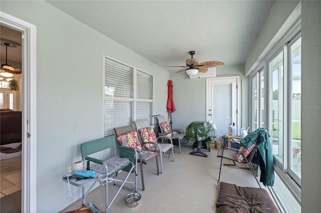 sunroom / solarium featuring ceiling fan