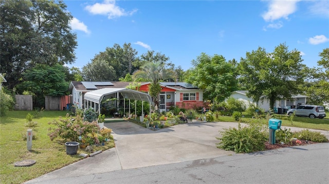 view of front of home featuring solar panels, a carport, and a front yard