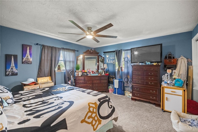 bedroom featuring carpet floors, a textured ceiling, and ceiling fan