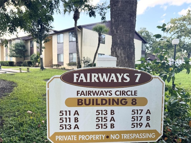 community sign featuring a yard