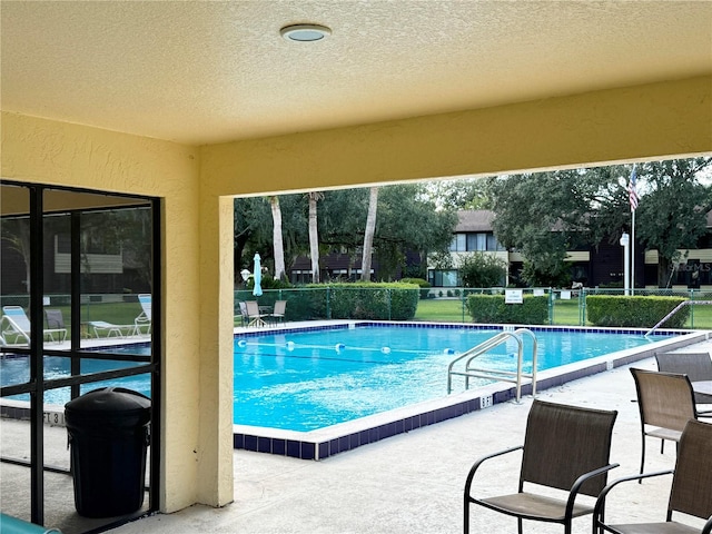 view of swimming pool with a patio area