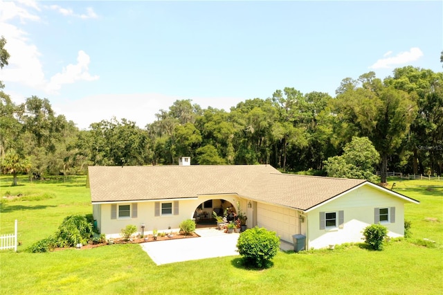 ranch-style home with a garage and a front yard