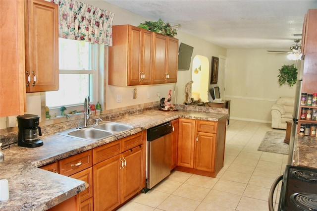 kitchen featuring light tile patterned floors, dishwasher, ceiling fan, sink, and range