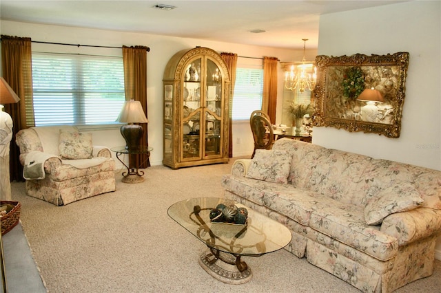 living room with an inviting chandelier and carpet