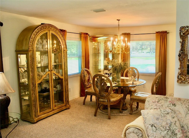 carpeted dining area featuring an inviting chandelier