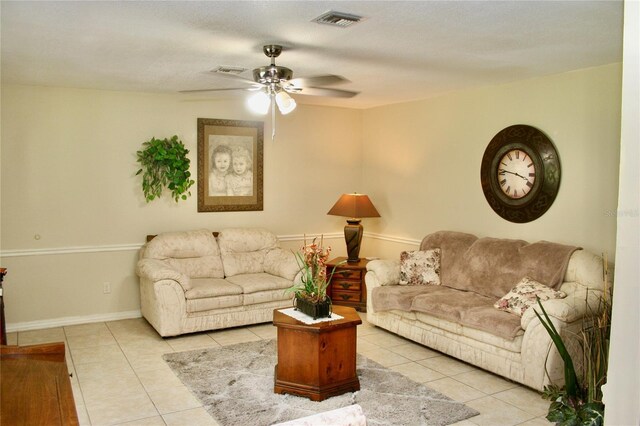 living room with ceiling fan and light tile patterned floors