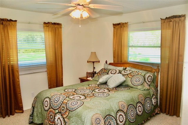 bedroom with ceiling fan and carpet floors