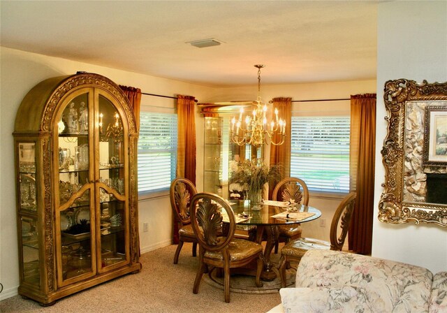 dining space with a notable chandelier, carpet, and a wealth of natural light