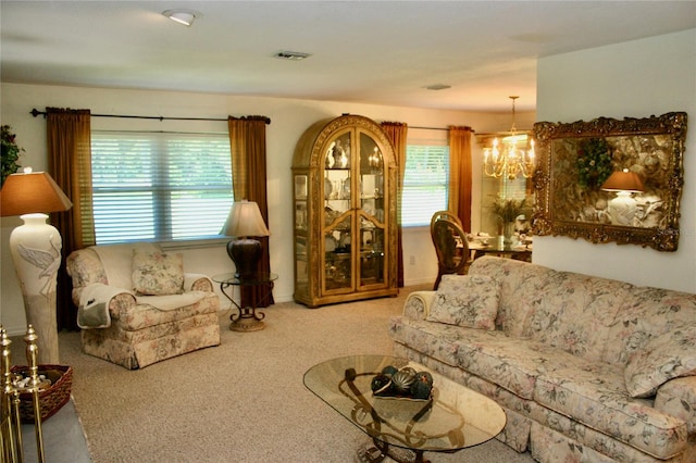 living room with a notable chandelier and light carpet