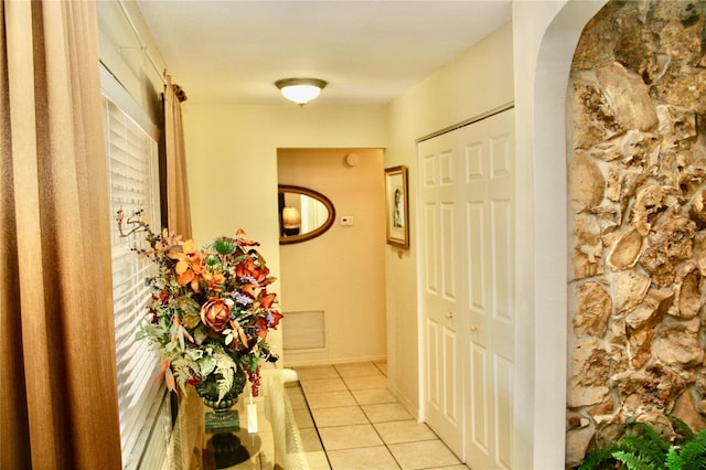 hall featuring light tile patterned floors