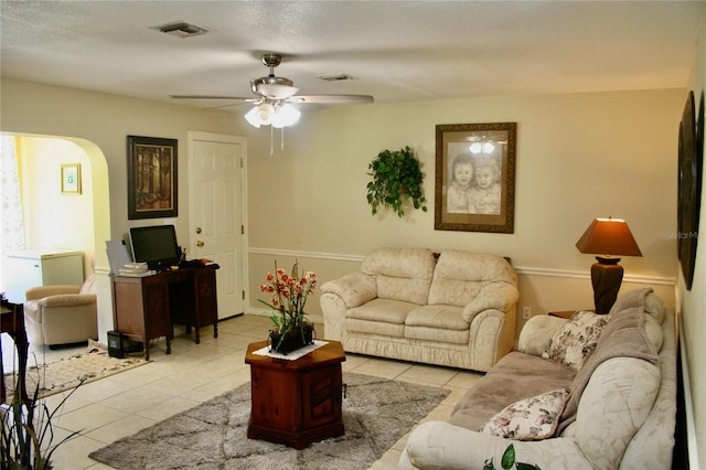 living room with ceiling fan and light tile patterned floors