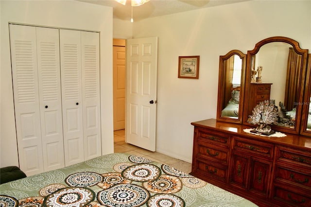 bedroom featuring light tile patterned floors and a closet