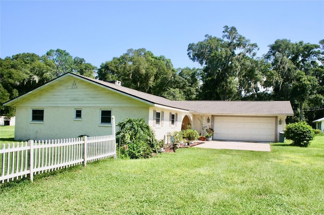 ranch-style home with a front lawn and a garage