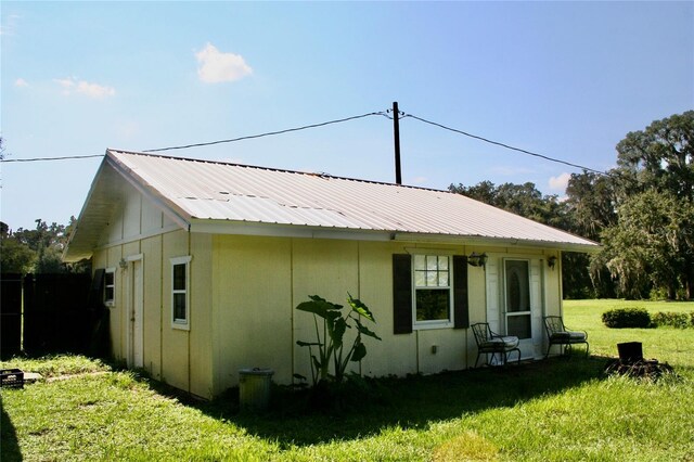 view of side of home featuring a yard