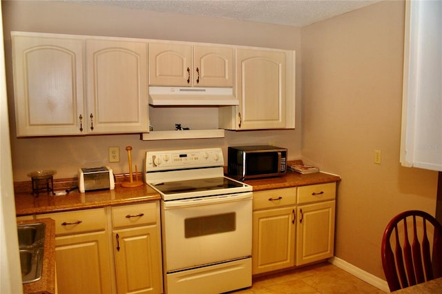 kitchen featuring electric range, light tile patterned floors, sink, and a textured ceiling