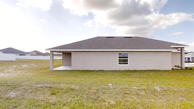 back of property with a patio area and a lawn