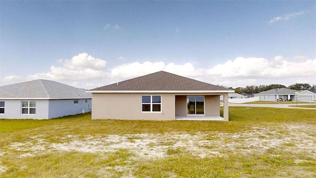 rear view of house featuring a patio area and a yard