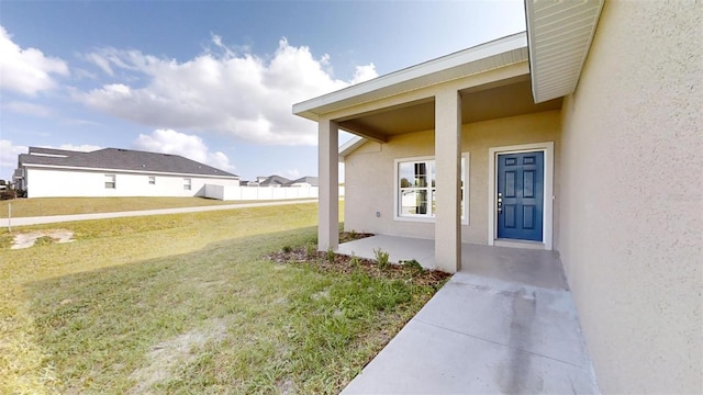 doorway to property with a yard