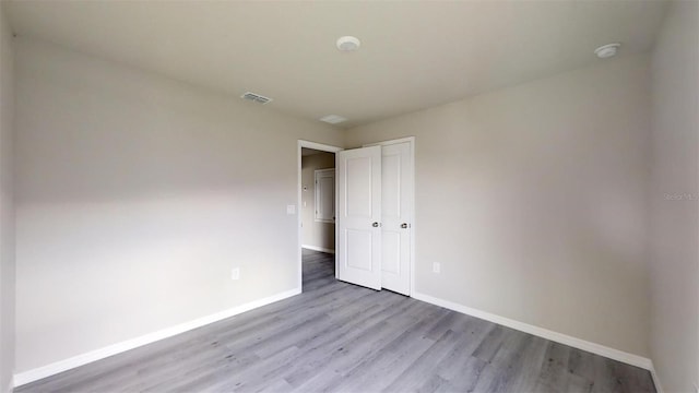 spare room with light hardwood / wood-style flooring