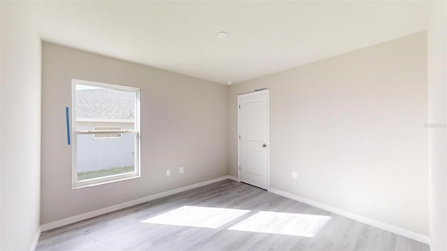 unfurnished room with light hardwood / wood-style floors